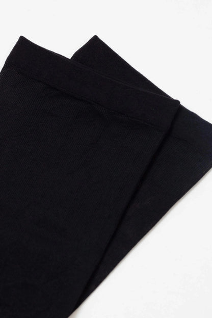 Two plain black socks displayed against a white background.