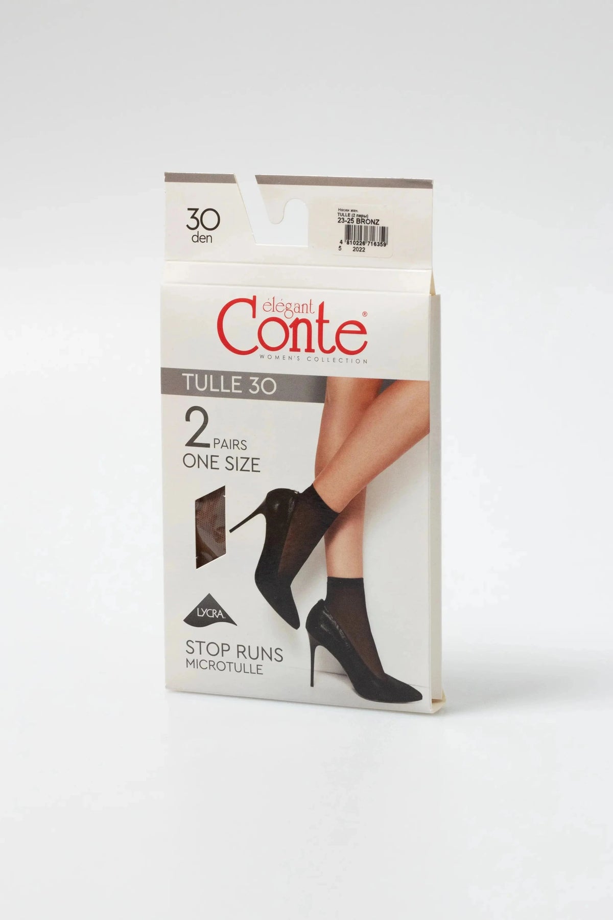 A pair of sheer ankle-high stockings shown on a model wearing black stiletto heels, packaged in a white box with black text.