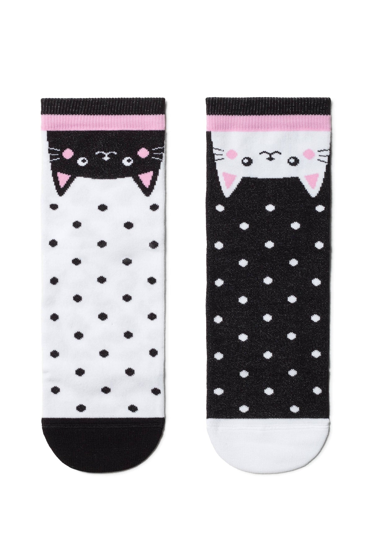 A pair of crew socks featuring a black cat face on a white polka dot background and a white cat face on a black polka dot background, both finished with pink and black striped cuffs.