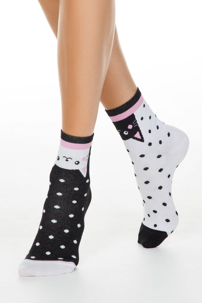 A pair of ankle socks featuring a cat face design and a black and white polka dot pattern on a neutral background.