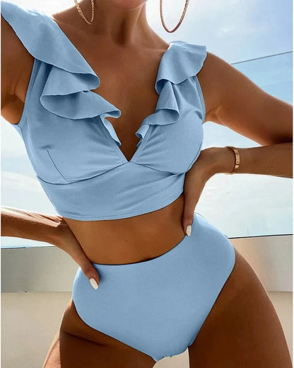 A light blue two-piece bikini set featuring a ruffled v-neck crop top and matching high-waisted bottoms.