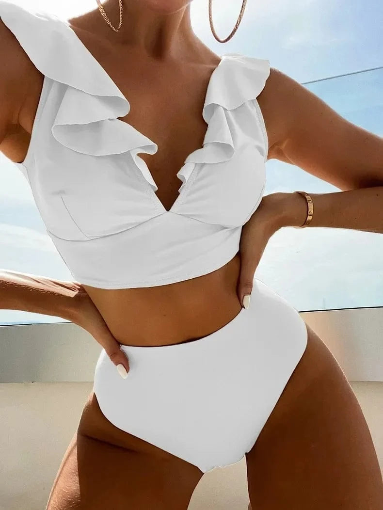 A white two-piece high-waisted bikini with ruffle detailing along the neckline of the crop top.