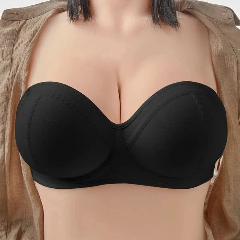A black strapless bra with molded cups worn by a person in a tan open-front shirt.