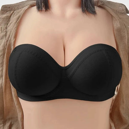 A black strapless bra with molded cups worn by a person in a tan open-front shirt.
