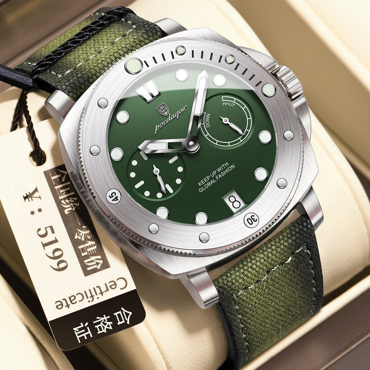 A round silver-toned wristwatch with a green dial features luminous indices, two sub-dials, a date window, and a green canvas strap, displayed with a hanging price tag.
