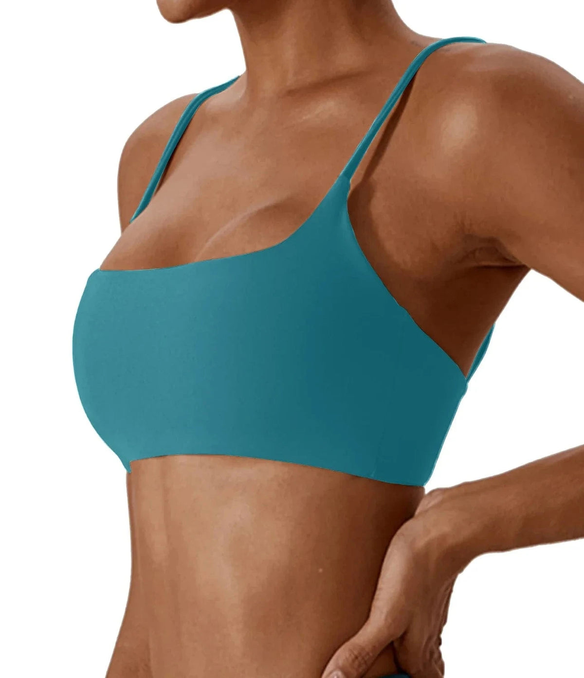 A teal-colored bikini top with a scoop neckline and thin spaghetti straps worn by a person.