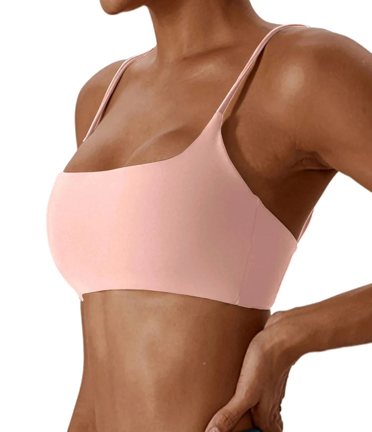 A light pink scoop neck bikini top with thin spaghetti straps worn by a person.