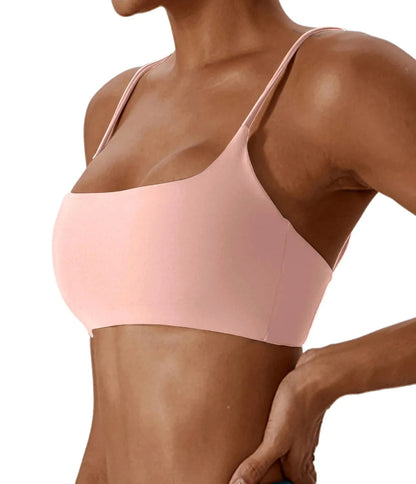 A light pink scoop neck bikini top with thin spaghetti straps worn by a person.