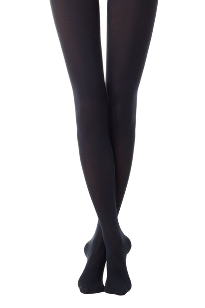 Opaque black tights shown on a pair of crossed legs against a plain white background.