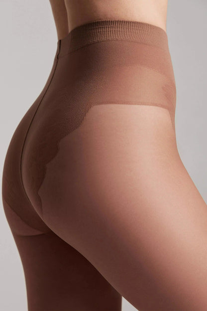 Tan pantyhose worn on a person, featuring a reinforced shaping brief with a distinct lace-like pattern along the hips and rear.