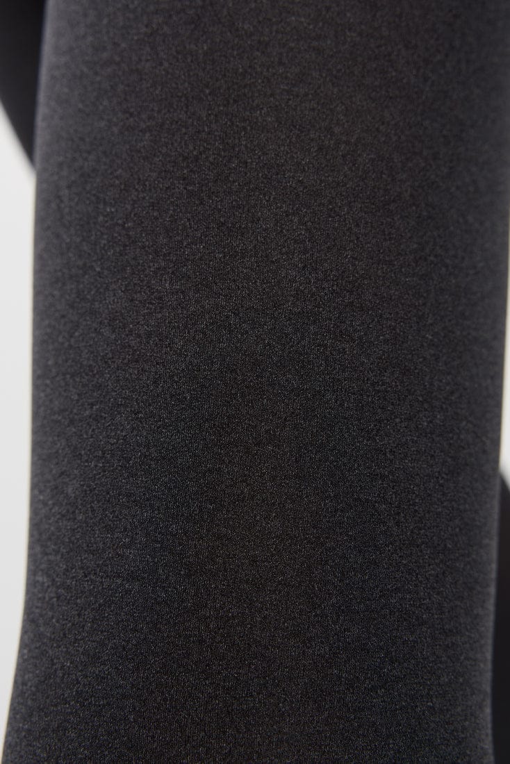 A close-up view of dark black fabric with a fine, uniform textured weave.