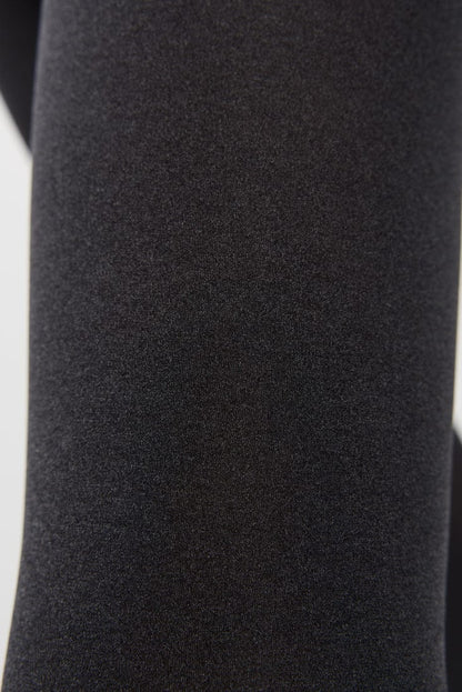 A close-up view of dark black fabric with a fine, uniform textured weave.