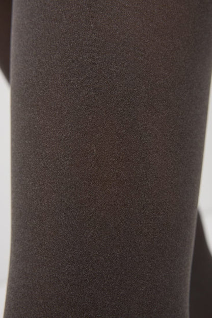 A close-up view of smooth, dark brown fabric with a fine, uniform knit texture.