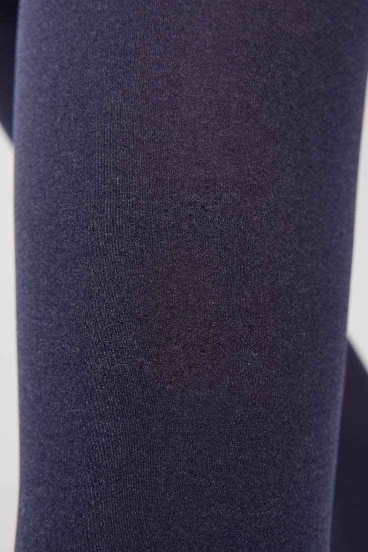 A close-up of dark blue fabric with a fine, textured knit pattern.