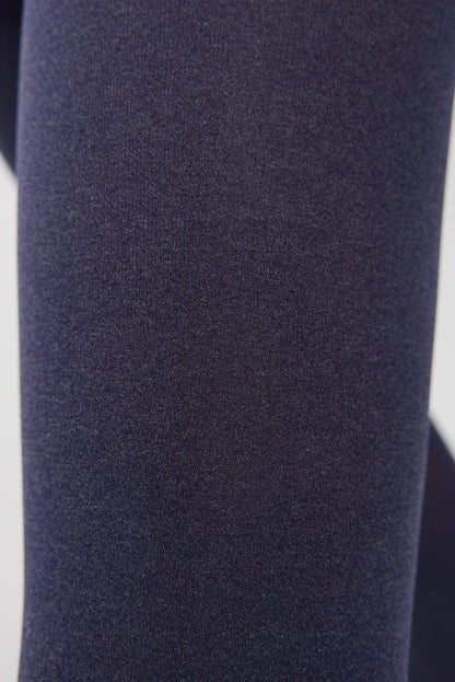 A close-up of dark blue fabric with a fine, textured knit pattern.
