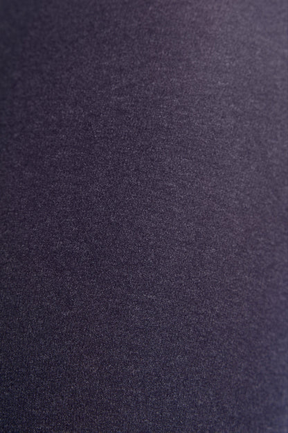 A close-up view of solid dark purple fabric with a fine, smooth knit texture.