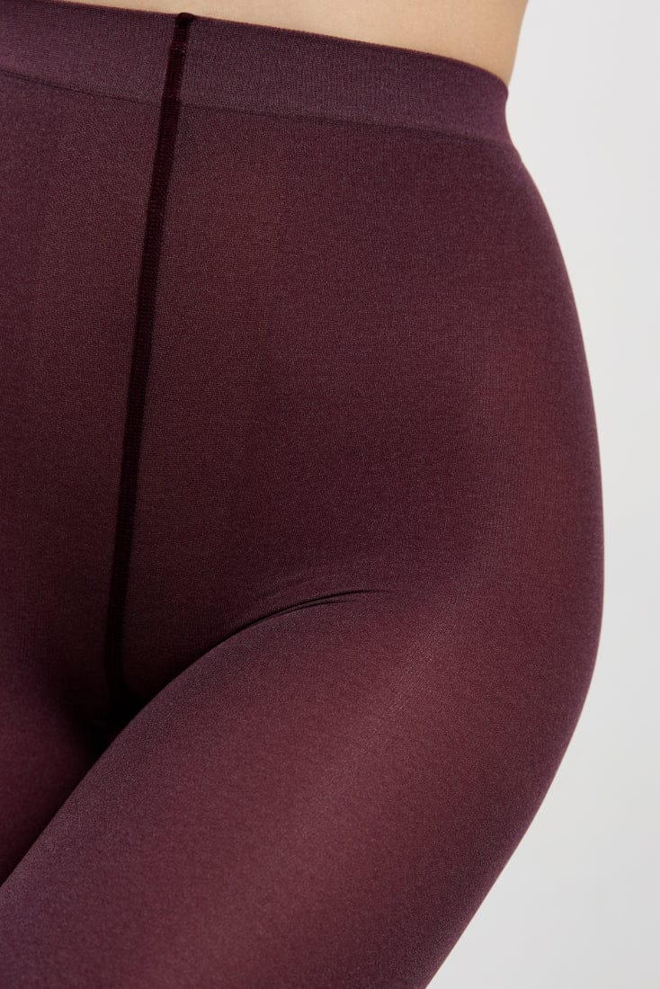 Dark burgundy tights featuring a thick, smooth waistband and a reinforced seam running down the center front.