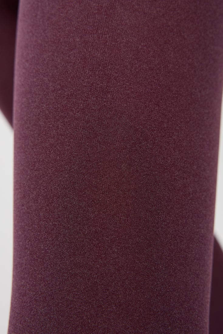 A close-up view of maroon-colored, smooth fabric texture.