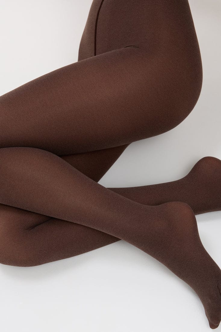Opaque chocolate brown tights worn on a pair of crossed legs against a plain white background.