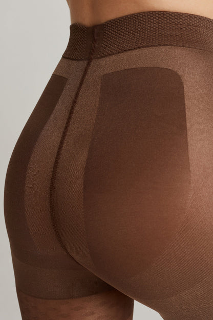 Brown shaping tights worn on a person, featuring a high, textured waistband and reinforced contour panels across the hips and glutes.