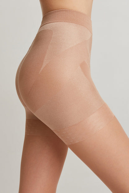 A side view of a person wearing nude-colored seamless shapewear shorts that extend from the high waist to the mid-thigh.