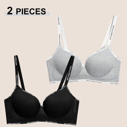 Two women's bras are displayed against a plain background, with one black and one grey version, both featuring thin straps printed with the text SEXY BEAUTY GIRL.