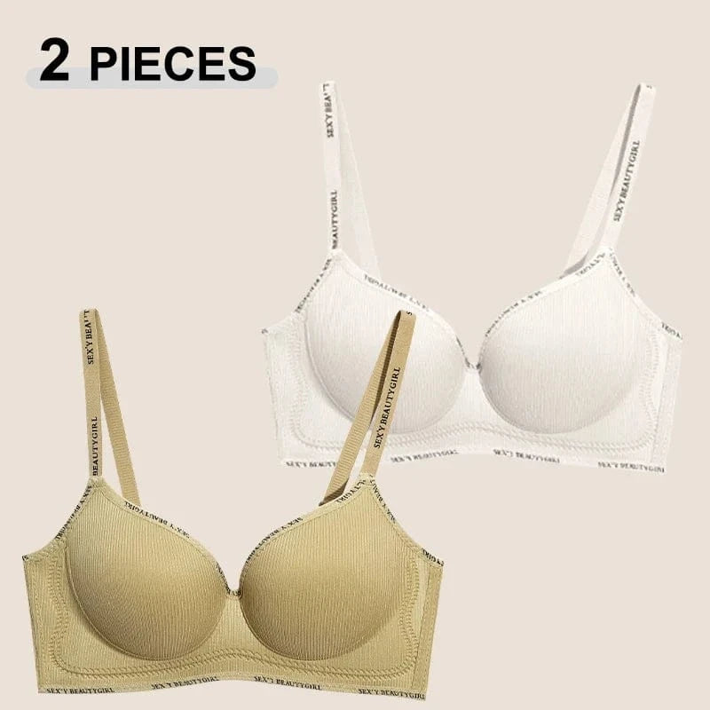 Two wireless bras featuring ribbed fabric and adjustable shoulder straps with printed lettering, displayed in beige and white.