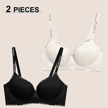 Two push-up bras in black and white featuring ribbed fabric and elastic straps printed with the phrase SEXY BEAUTY GIRL.