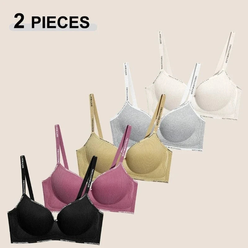 A collection of five wireless bras featuring ribbed fabric cups and branded shoulder straps, displayed in black, dark pink, tan, grey, and cream.