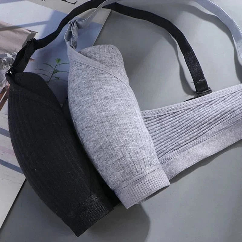A black and a grey ribbed fabric bralette are shown folded together on a flat surface with black adjustable straps.