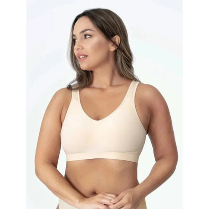 A woman wearing a beige seamless bralette with a V-neckline against a plain white background.