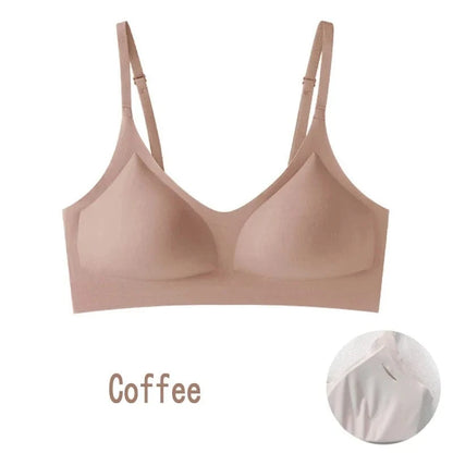 A coffee-colored wireless bra with a seamless design, thin adjustable shoulder straps, and molded cups, shown against a white background with a zoomed-in circular inset detail.