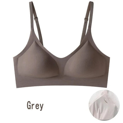 A grey seamless wireless bra with thin adjustable straps and moulded cups, shown with a small inset detail of the inner cup fabric.