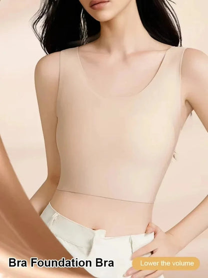 A beige seamless scoop-neck camisole-style bra worn by a person with dark hair against a neutral background.