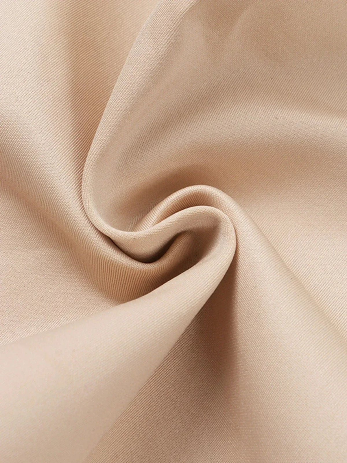 Beige fabric draped in a soft, elegant fold showcasing a smooth, uniform texture.
